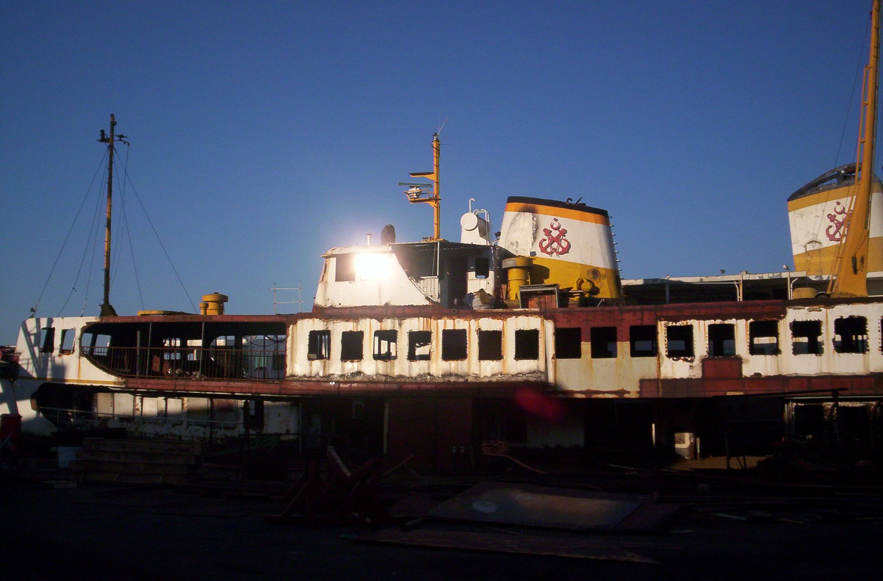 A ferry in sunlight under a blue sky.